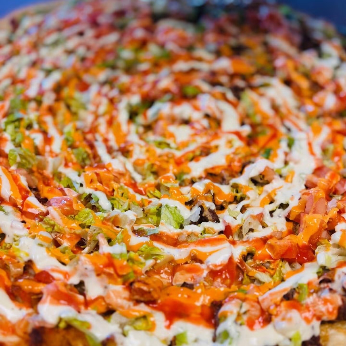Loaded specialty pizza with vegetables and sauces